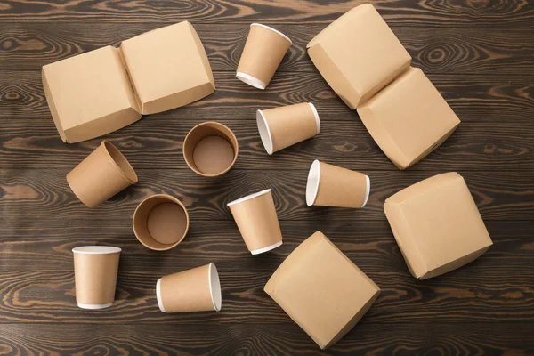 Biodegradable tableware on wooden background. Secondary processing. The concept of zero waste.