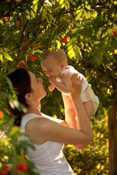 Щаслива Жінка Тримає Руці Сміху Дитину Саду Щаслива Сім — стокове фото