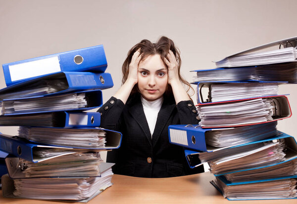Busy manager.  Businesswoman with stack of folders and documents. Concept of hard work.