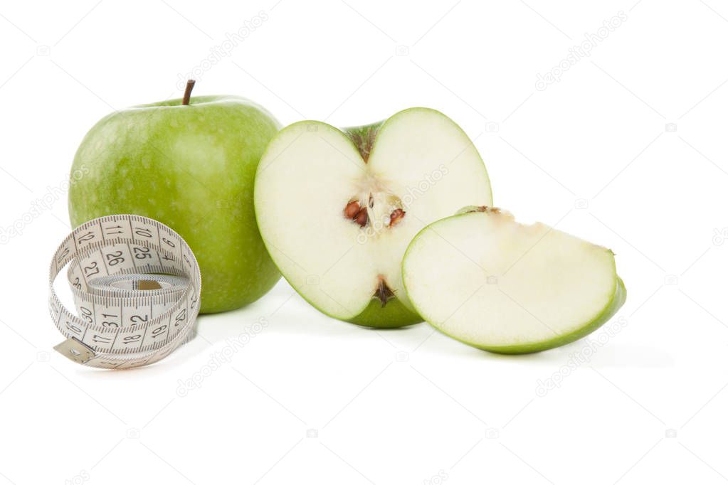 Picture of green apples and tape measure isolated on white. Healthy food.