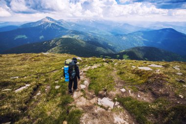 Bir turist bir dağ dolambaçlı yol yürür. Dağlarda yürüyüş yaz