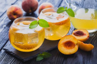 Olgun şeftali buz ve siyah bir tablo taze nane kokteyli. canlandırıcı yaz içeceği