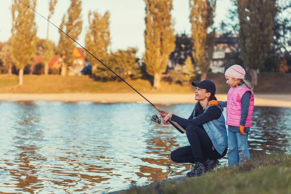 幸福的母女俩在湖上钓鱼 家庭活动 — 图库照片
