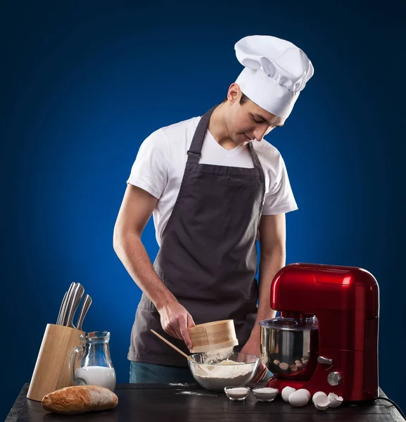 Chef Prepares Delicious Dish Blue Background Studio Photo — Stock Photo, Image