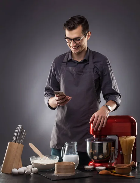 Handsome Man Prepares Delicious Dish Gray Background Studio Photo — Stock Photo, Image