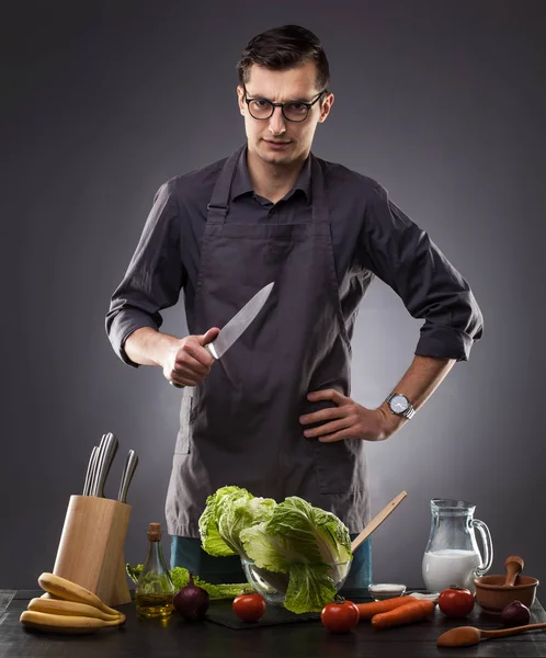Handsome Man Prepares Delicious Dish Gray Background Studio Photo — Stock Photo, Image