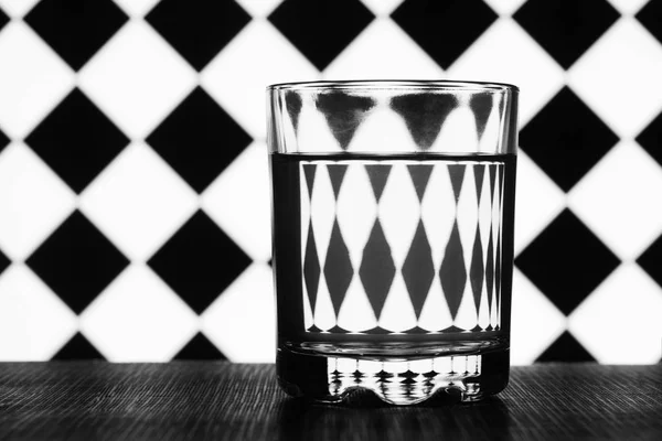 黒と白の幾何学的図形の背景の水のガラス — ストック写真