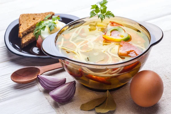 Fresh vegetable soup with noodles in a pot on the white wooden background — Stock Image Fresh Vegetable Soup Noodles Pot White Wooden Background Stock Photo