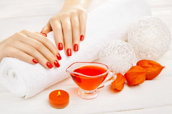 Piękny Czerwony Manicure Ręcznikiem Biały Drewniany Stół Dekor Spa — Zdjęcie stockowe