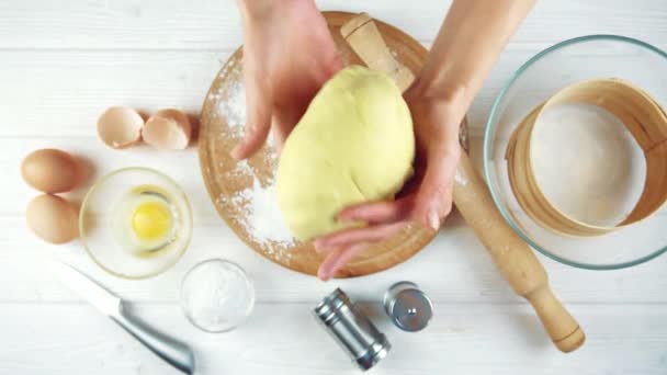 Femme cuisinière pétrit la pâte sur une table en bois. — Video