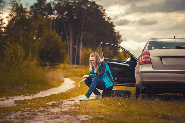그림같이 아름다운 도로에서 자동차를 타고 있던 한 여자가 바퀴를 쳤다. — 스톡 사진