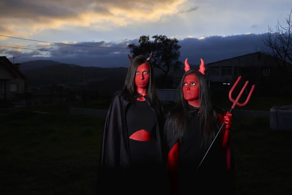 Dos mujeres jóvenes disfrazadas de diablo en Halloween en España —  Fotos de Stock