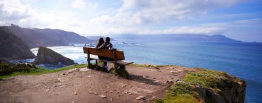 Panoramic view of a couple in the best bench of the world clipart