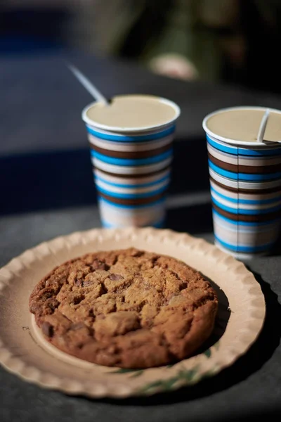 two coffees and a big cookie