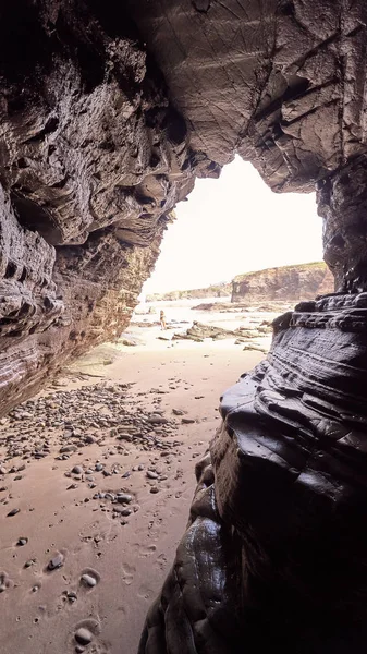 Paesaggio di una spiaggia con scogliere rocciose in Galizia dall'interno di una grotta — Foto Stock