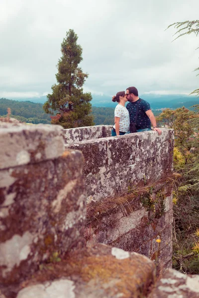 Pregnant couple of tourists on the medieval castle of Soutomaior, in Galicia, Spain