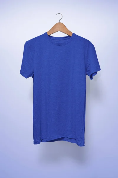 Dark blue T-Shirt on a hanger against a light blue background