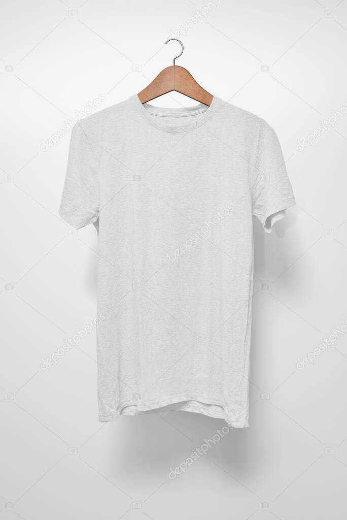 White T-Shirt on a hanger against a white background