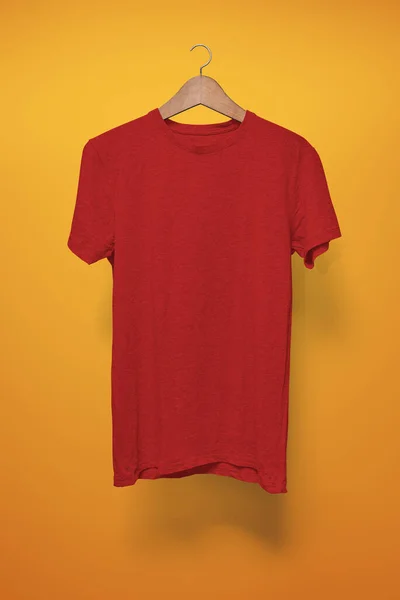 Red T-Shirt on a hanger against an orange background