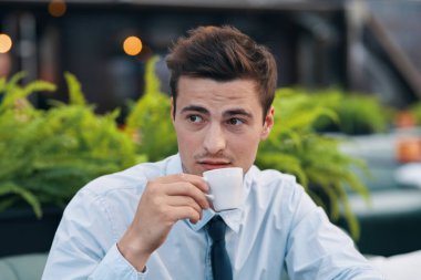 Kafedeki genç ve yakışıklı iş adamı. 