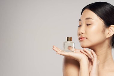 young asian woman with perfume