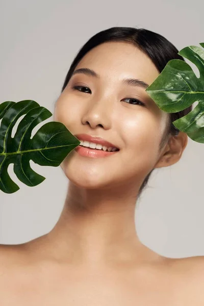portrait of young asian woman with leaves