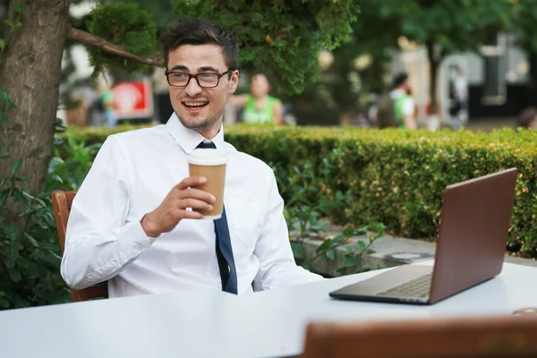 Young handsome  businessman with coffee  in cafe