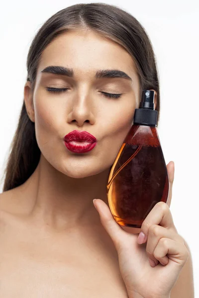 Portrait of  beautiful woman with beauty product. Studio shot