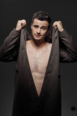 Stüdyoda poz veren genç yakışıklı adam.