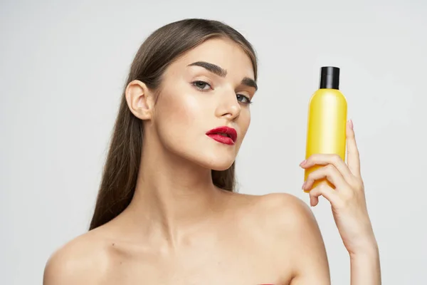 Portrait of  beautiful woman with beauty product. Studio shot