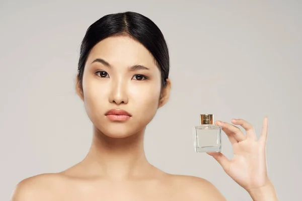 young asian woman with perfume