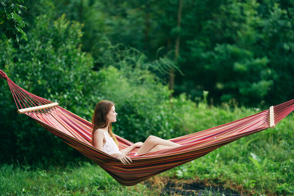 Young beautiful woman relaxing in hammock