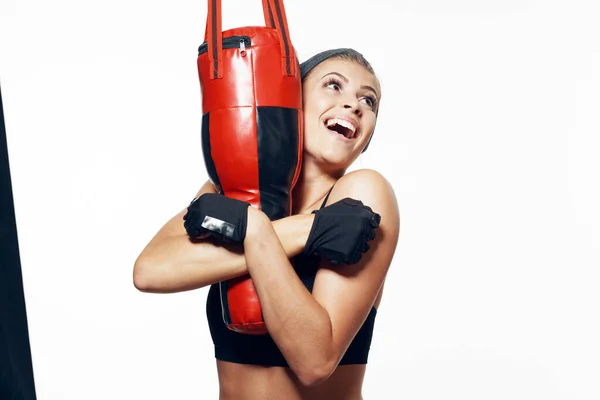 Studio shot. Young fit woman boxer exercising, isolated background