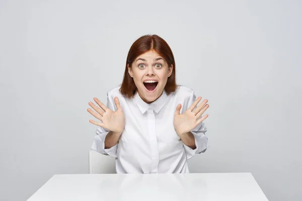 young happy surprised businesswoman sitting in the office