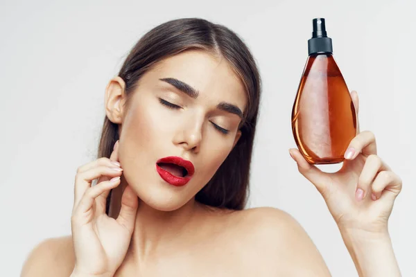 Portrait of  beautiful woman with beauty product. Studio shot