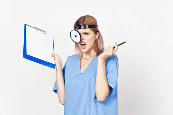 Young female angry doctor with document   in studio on white background