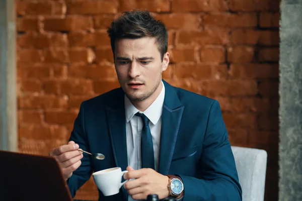 Young  businessman with coffee cup   in the office