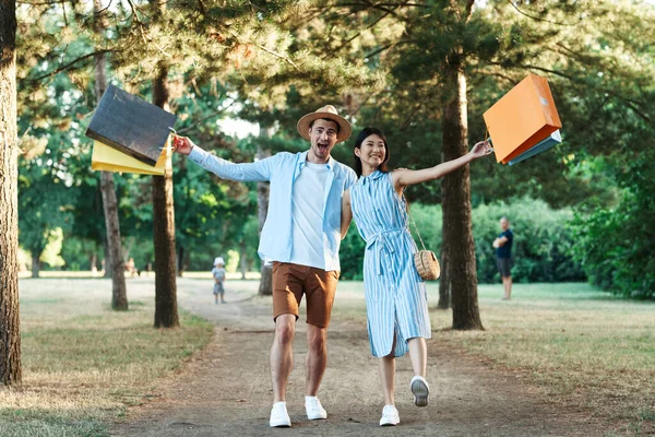 stock image young couple with shopping bags  in the park