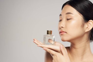 young asian woman with perfume