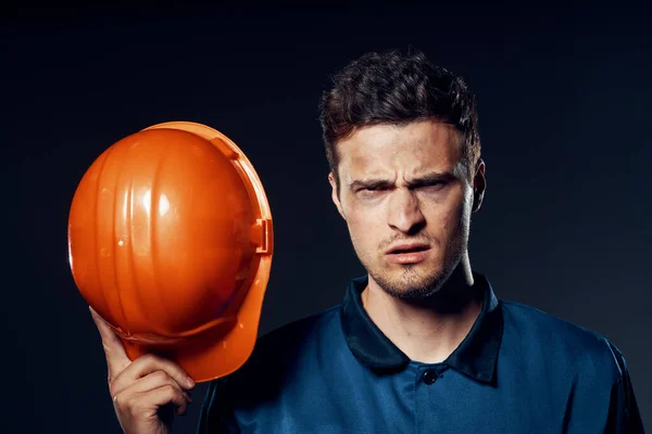 Studio shot. Industrial  worker with  orange helmet