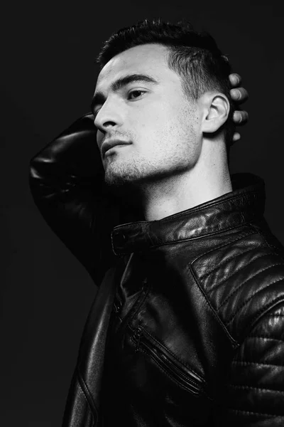 portrait of young handsome man in leather jacket. Studio shot. Fashion photography