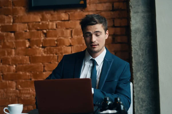 young handsome businessman in cafe  with laptop