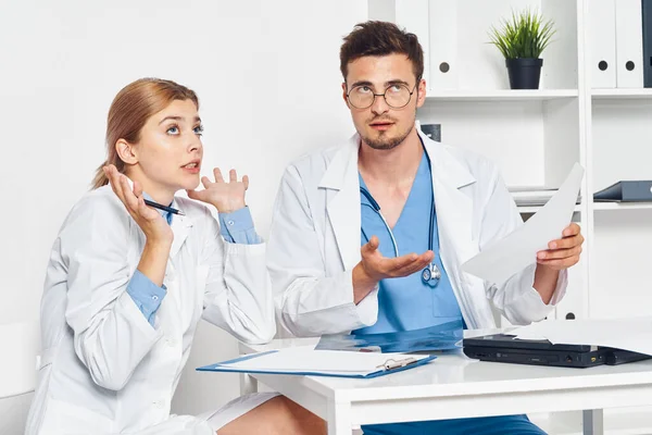 confused doctor and nurse working  in hospital office