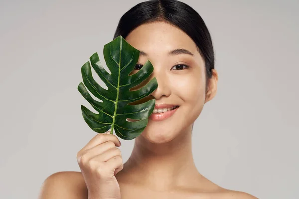 portrait of young asian woman with leaf