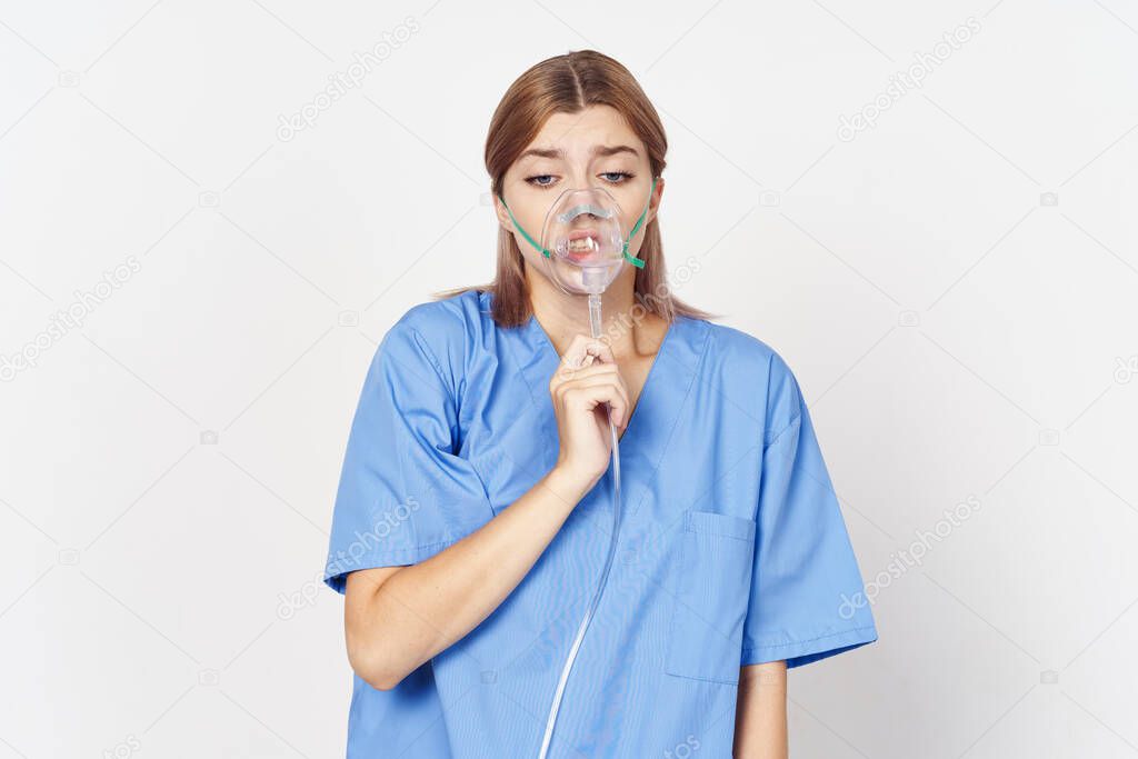 Young woman in uniform  with inhaler on isolated on white 