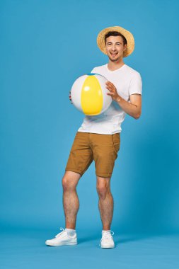 Genç adam stüdyoda topla oynuyor. 