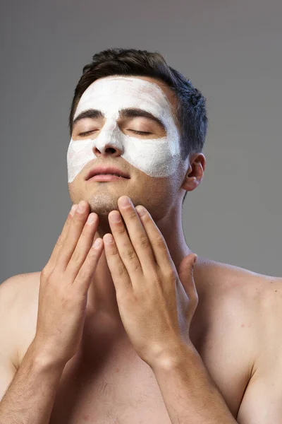 Young Man Applying Facial Mask — Stock Photo, Image