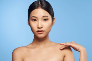 beautiful asian woman posing on blue 