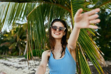 Genç ve güzel bir kadın sahilde dinleniyor.