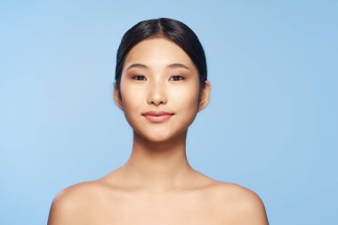 beautiful asian woman posing on blue background
